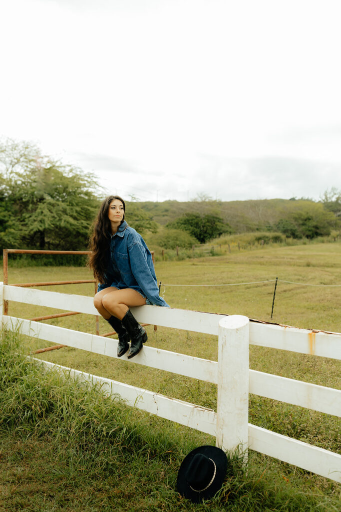 girl sitting on a fence during her lifestyle photoshoot