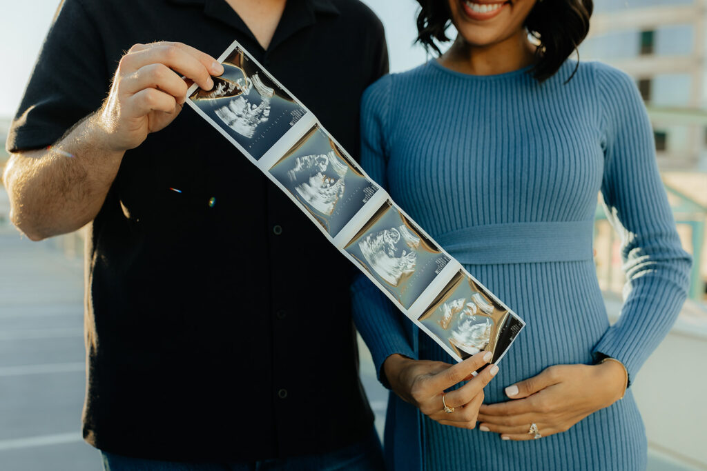 happy soon to be parents holding their baby sonogram