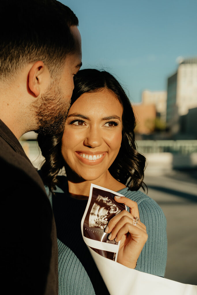 happy soon to be parents holding their bay sonogram