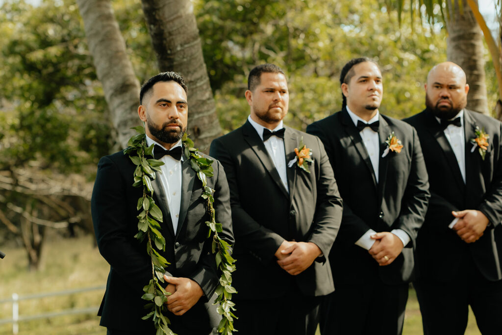 groom watching the bride walk down the aisle 