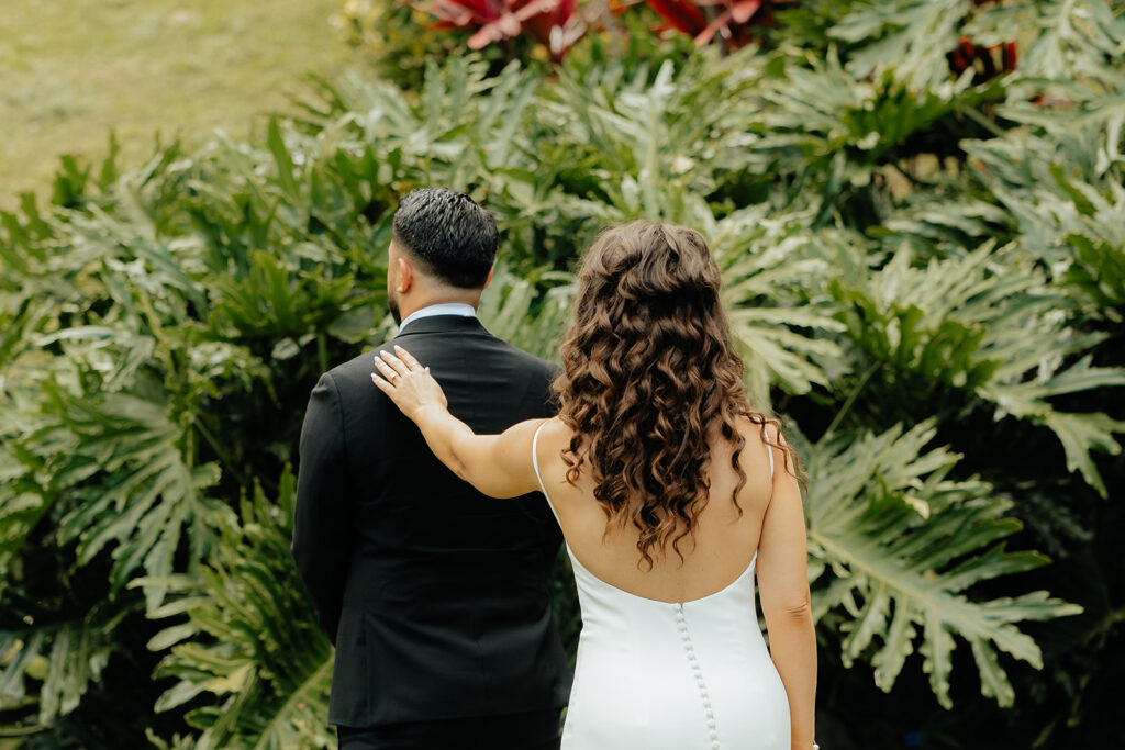 bride touching the grooms shoulder for their first look