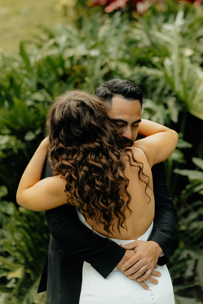 bride and groom hugging after their first look