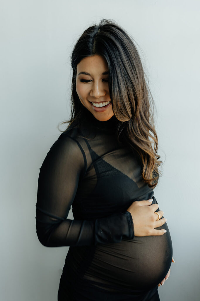 mom to be smiling during her maternity session 