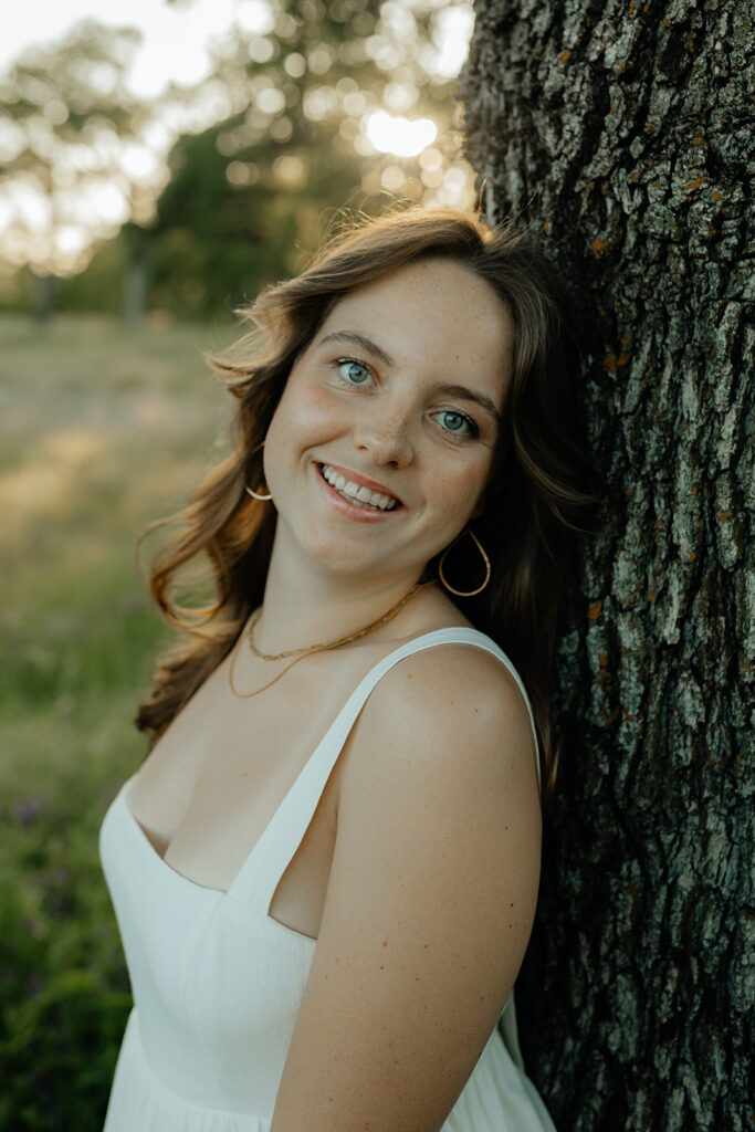 girl posing for the camera during her grad session