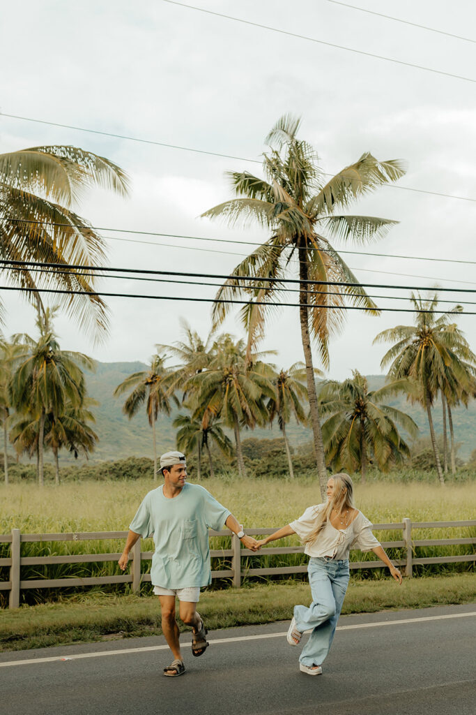 couple running holding hands during their photoshoot 