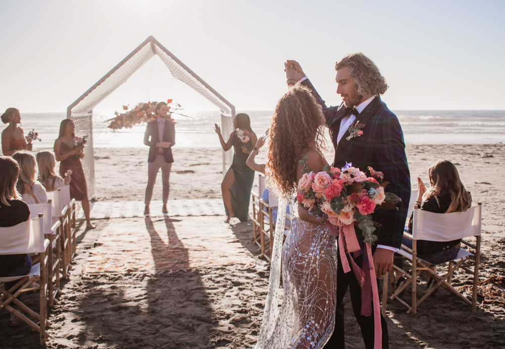 Rachel Christopherson San Luis Obispo Boho Beach Elopement Wedding Bride and Groom walking down aisle holding hands