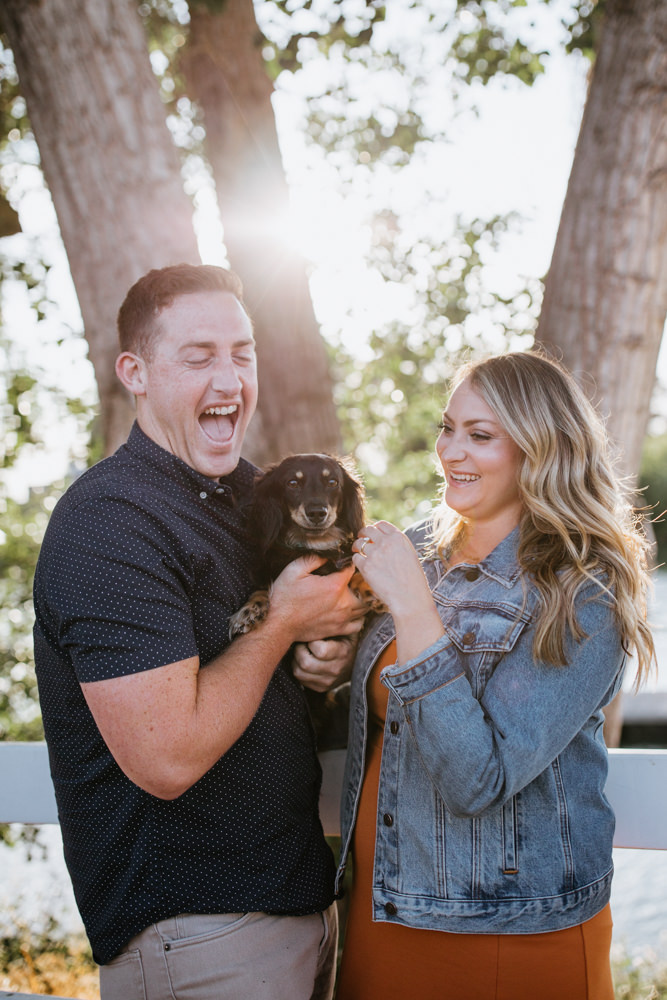 Sacramento River Engagement Session Northern California Weiner dog engagement shoot outfit inspo engagement photos with dog couples shoot posing golden hour sacramento river rachel christopherson photography smiling dog