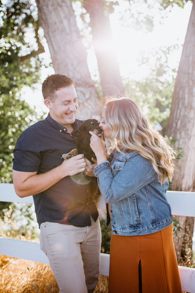 Sacramento River Engagement Session Northern California Weiner dog engagement shoot outfit inspo engagement photos with dog couples shoot posing golden hour sacramento river rachel christopherson photography filtered sunshine