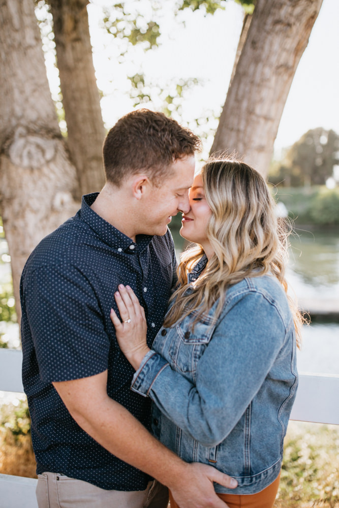 Sacramento River Engagement Session Northern California Weiner dog engagement shoot outfit inspo engagement photos with dog couples shoot posing golden hour sacramento river rachel christopherson photography almost kiss