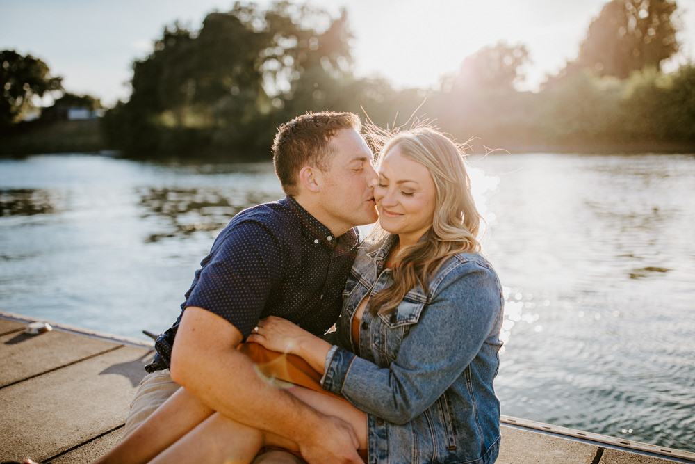 Sacramento River Engagement Session Northern California Weiner dog engagement shoot outfit inspo engagement photos with dog couples shoot posing golden hour sacramento river rachel christopherson photography boat dock cheek kiss