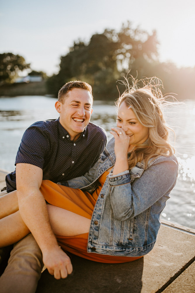 Sacramento River Engagement Session Northern California Weiner dog engagement shoot outfit inspo engagement photos with dog couples shoot posing golden hour sacramento river rachel christopherson photography dock laughter