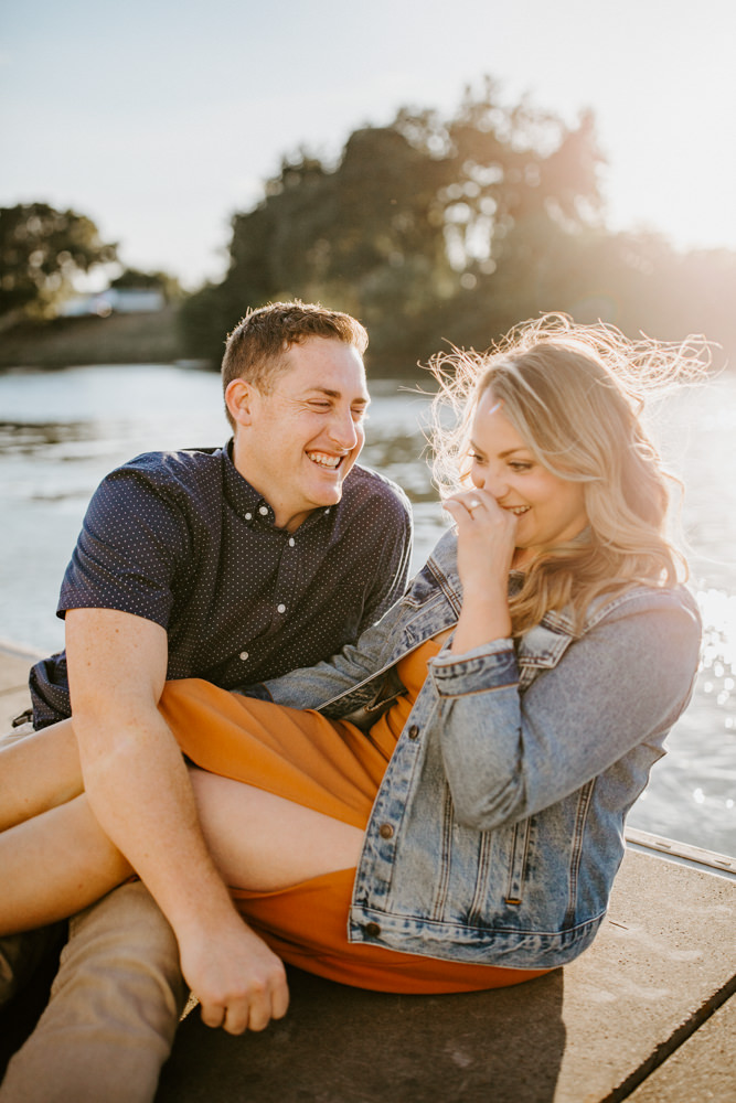 Sacramento River Engagement Session Northern California Weiner dog engagement shoot outfit inspo engagement photos with dog couples shoot posing golden hour sacramento river rachel christopherson photography boat dock giggles