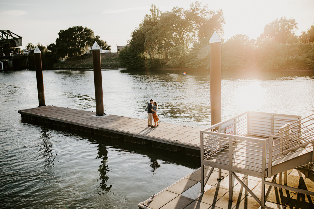 Sacramento River Engagement Session Northern California Weiner dog engagement shoot outfit inspo engagement photos with dog couples shoot posing golden hour sacramento river rachel christopherson photography far away dock kiss