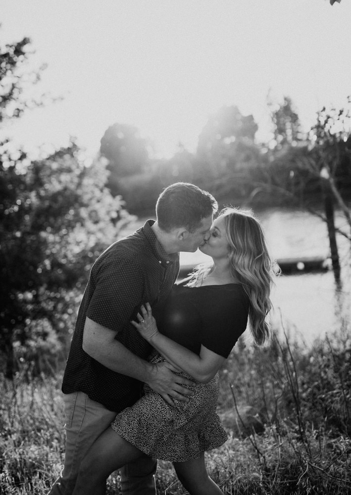 Sacramento River Engagement Session Northern California Weiner dog engagement shoot outfit inspo engagement photos with dog couples shoot posing golden hour sacramento river rachel christopherson photography black and white in grass over river