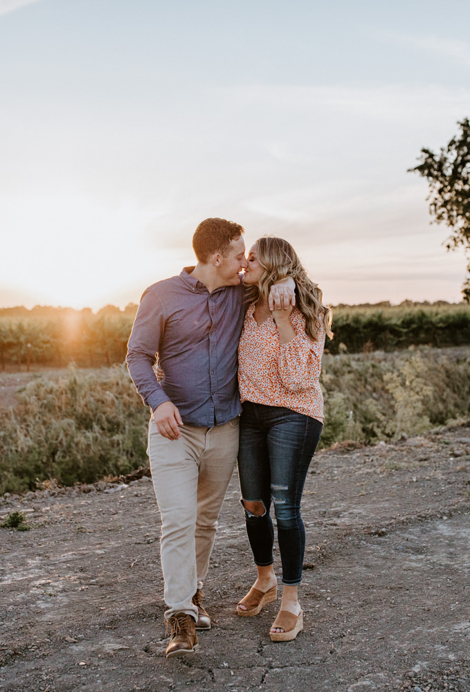 Sacramento River Engagement Session Northern California Weiner dog engagement shoot outfit inspo engagement photos with dog couples shoot posing golden hour sacramento river rachel christopherson photography warm golden sunset almost kiss walk
