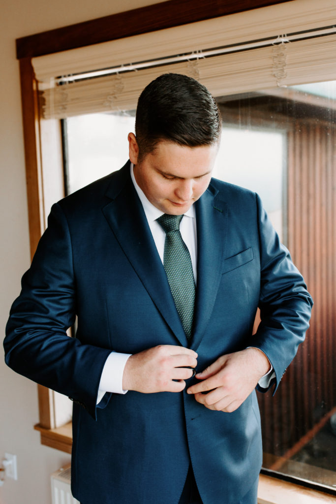 groom photos, groom buttoning jacket, christmas elopement, best places to elope in california, norcal elopement, northern california elopement, elopement inspo, california coast elopement, Rachel Christopherson Photography