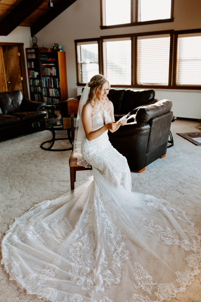 bride reading wedding letter, wedding dress train, christmas elopement, best places to elope in california, norcal elopement, northern california elopement, elopement inspo, california coast elopement, Rachel Christopherson Photography