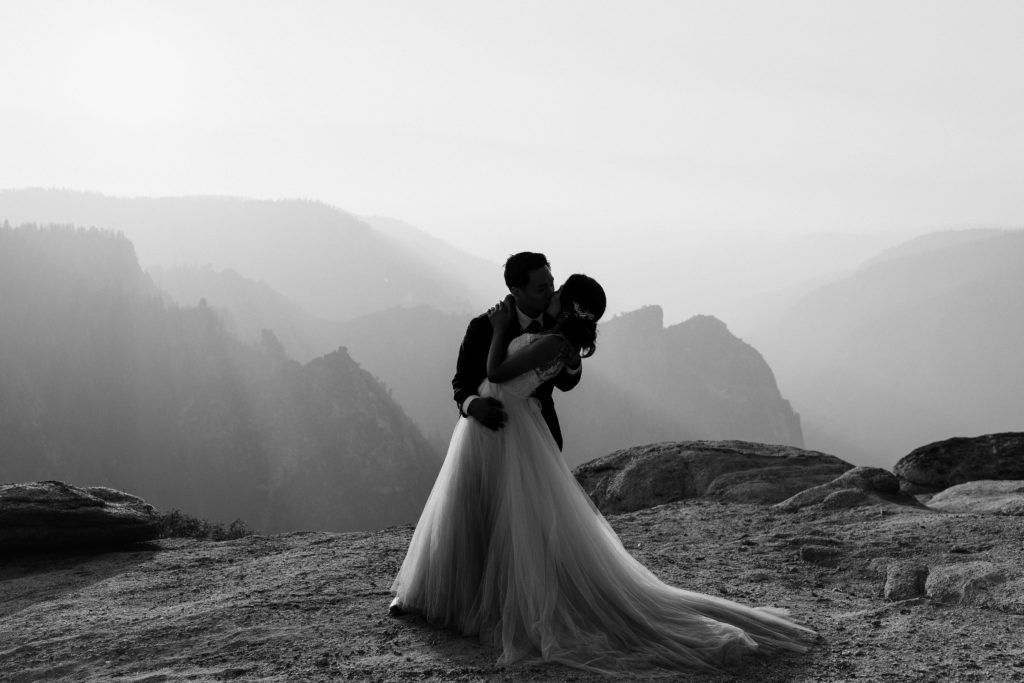 Black and white photos of Bride and groom kissing at taft point in Yosemite, Rachel Christopherson Photography LLC