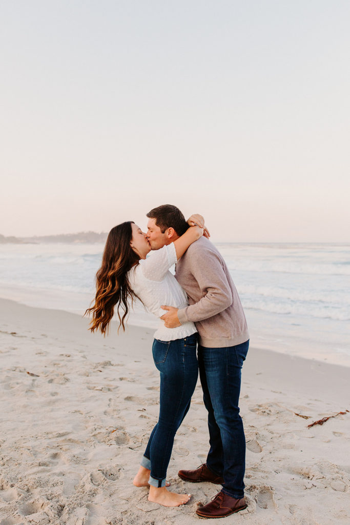 couple on beach kissing, Carmel CA Engagement Photos, Monterey Engagement Photos, Monterey Engagement Photo Locations, Engagement Photo Outfits, California Beach Engagement Photos, Best Locations for Monterey Engagement Photos, What to Wear for Engagement Photos, Rachel Christopherson Photography LLC