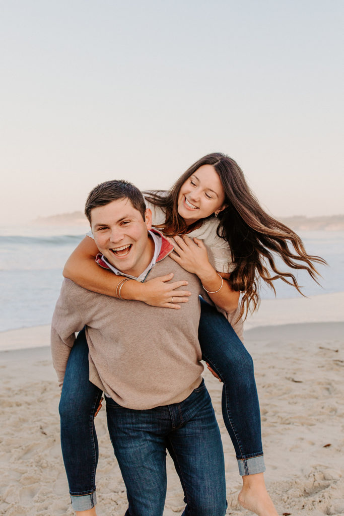 piggy back on beach, Carmel CA Engagement Photos, Monterey Engagement Photos, Monterey Engagement Photo Locations, Engagement Photo Outfits, California Beach Engagement Photos, Best Locations for Monterey Engagement Photos, What to Wear for Engagement Photos, Rachel Christopherson Photography LLC