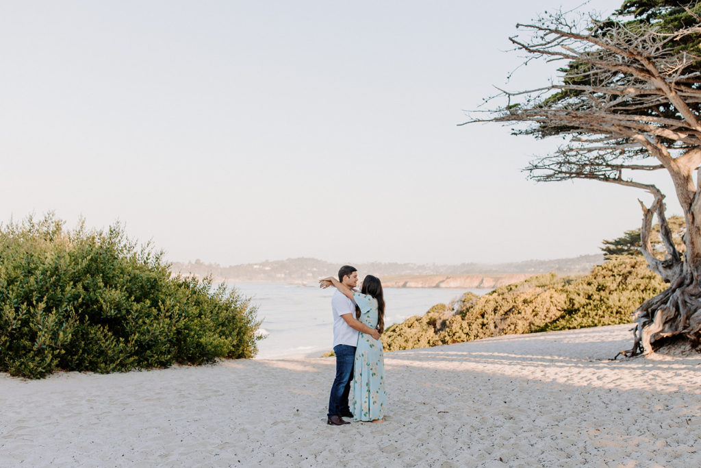 couple hugging at beach, Carmel CA Engagement Photos, Monterey Engagement Photos, Monterey Engagement Photo Locations, Engagement Photo Outfits, California Beach Engagement Photos, Best Locations for Monterey Engagement Photos, What to Wear for Engagement Photos, Rachel Christopherson Photography LLC