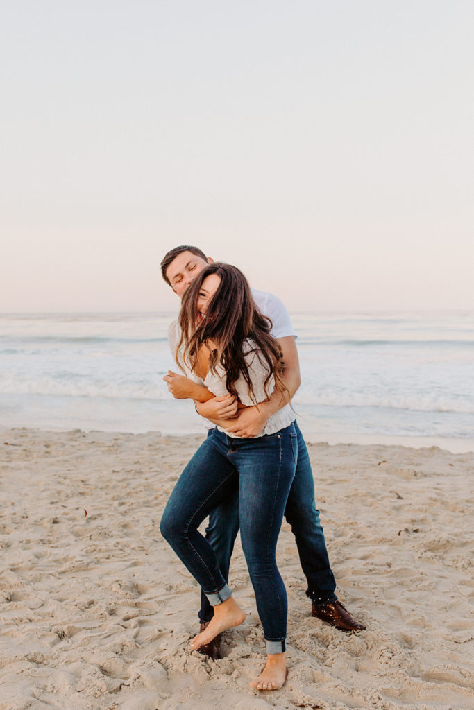 couple playing on beach, Carmel CA Engagement Photos, Monterey Engagement Photos, Monterey Engagement Photo Locations, Engagement Photo Outfits, California Beach Engagement Photos, Best Locations for Monterey Engagement Photos, What to Wear for Engagement Photos, Rachel Christopherson Photography LLC