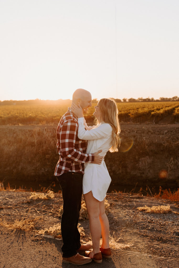 couple laughing during sunset, vineyard engagement photos, Sacramento engagement photos, sacramento engagement, sacramento engagement photographer sacramento engagement photo locations, sacramento wedding photographer, rachel christopherson photography, engagement photo outfit inspo