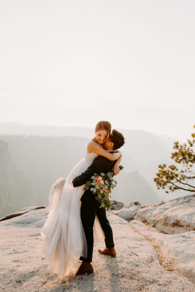 Bride in grooms arms at Taft Point, Taft Point elopement, Yosemite Elopement, Glacier Point Elopement, best places to elope in california, northern california elopement, Rachel Christopherson Photography