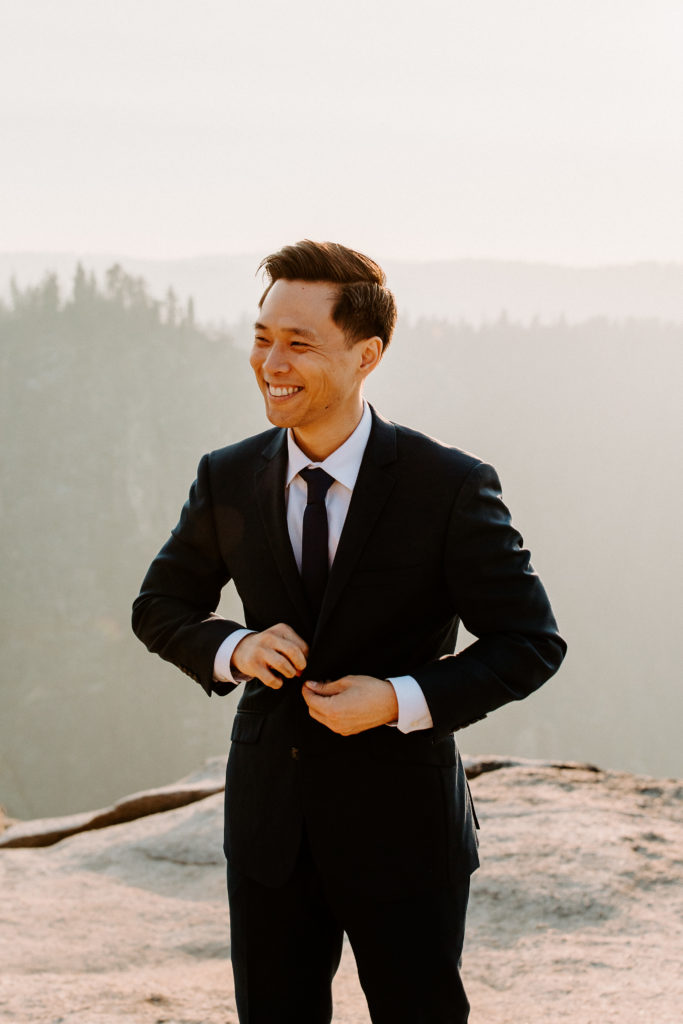 groom buttoning jacket, Taft Point elopement, Yosemite Elopement, Glacier Point Elopement, best places to elope in california, northern california elopement, Rachel Christopherson Photography