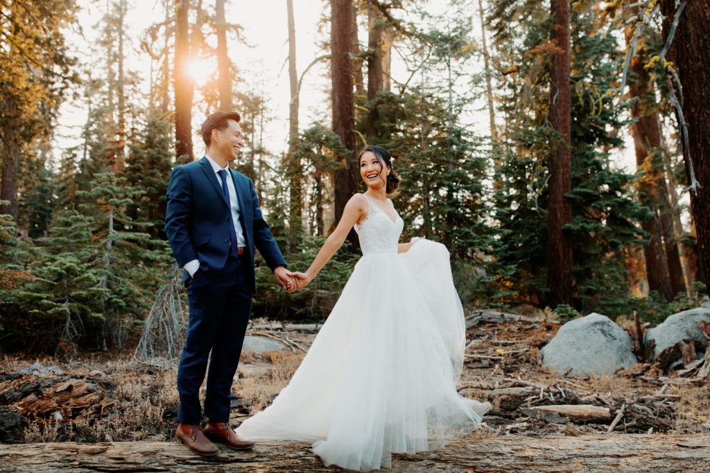bride and groom laugh and walk across log in forest, Taft Point elopement, Yosemite Elopement, Glacier Point Elopement, best places to elope in california, northern california elopement, Rachel Christopherson Photography