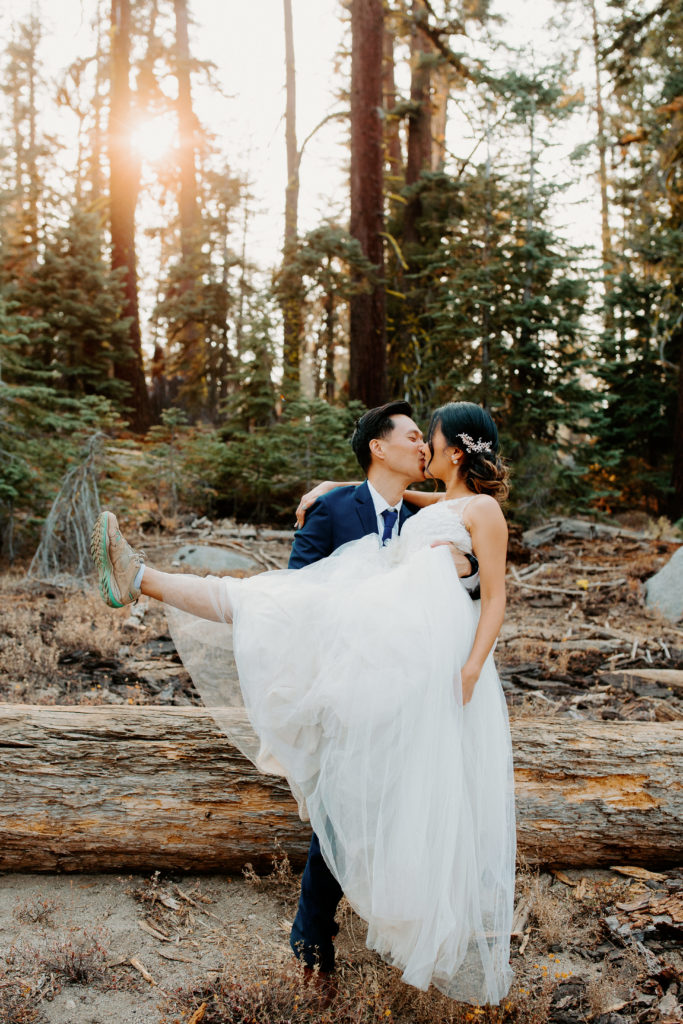 groom holds bride while kissing, adventurous bride, wedding dress and hiking boots, Taft Point elopement, Yosemite Elopement, Glacier Point Elopement, best places to elope in california, northern california elopement, Rachel Christopherson Photography