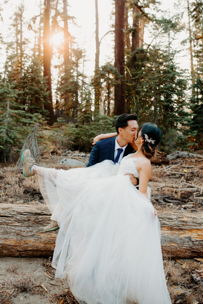 groom holds laughing bride, adventurous bride, wedding dress and hiking boots, Taft Point elopement, Yosemite Elopement, Glacier Point Elopement, best places to elope in california, northern california elopement, Rachel Christopherson Photography