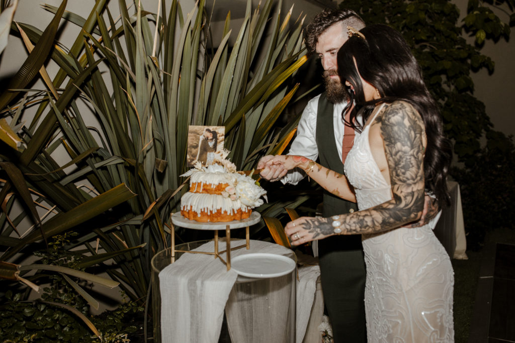 Rachel Christopherson Photography-Backyard Wedding-Unique Wedding Arch-Boho Wedding-Boho Bride-Edgy Wedding-Tattooed Bride-Tattooed Groom-Lake Tahoe Wedding-Northern California Wedding-Nor Cal Wedding-Sacramento-Lake Tahoe-Monterey-Carmel-Santa Cruz-Big Sur-Yosemite-Mendocino-Wedding and Elopement Photographer-Wedding Details-Wedding Reception Cake Cutting