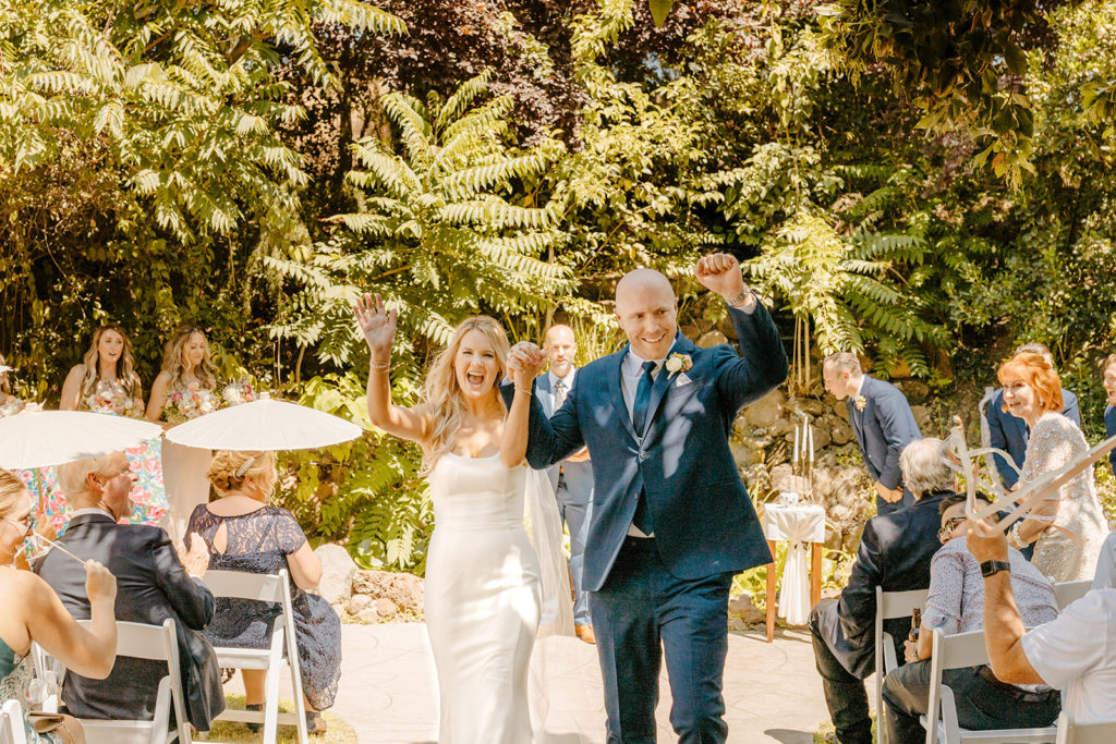 Rachel Christopherson Photography-Sacramento Garden Wedding-Rustic Wedding-Summer Wedding-Northern California-Nor Cal-Wedding Ceremony-Exchanging Vows-Wedding Dress With Train-Bridal Veil-Navy Groom's Suit-Ceremony Exit