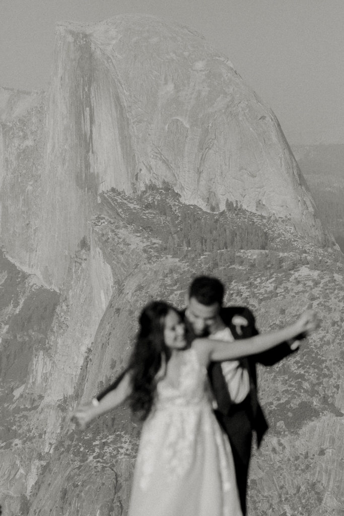rachelchristophersonphotos-glacier point yosemite elopement-yosemite elopement-glacier point elopement-mountain top elopement-northern california elopement-bride and groom-slick black suit-lacey floral wedding gown-black and white wedding photos