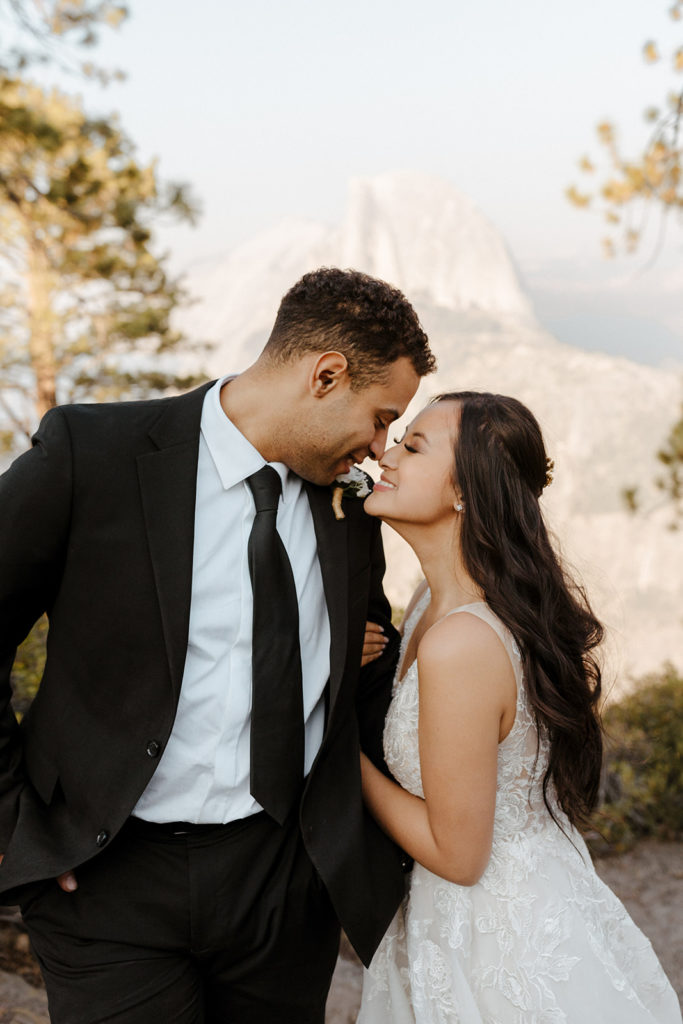 rachelchristophersonphotos-glacier point yosemite elopement-yosemite elopement-glacier point elopement-mountain top elopement-northern california elopement-bride and groom-slick black suit-lacey floral wedding gown