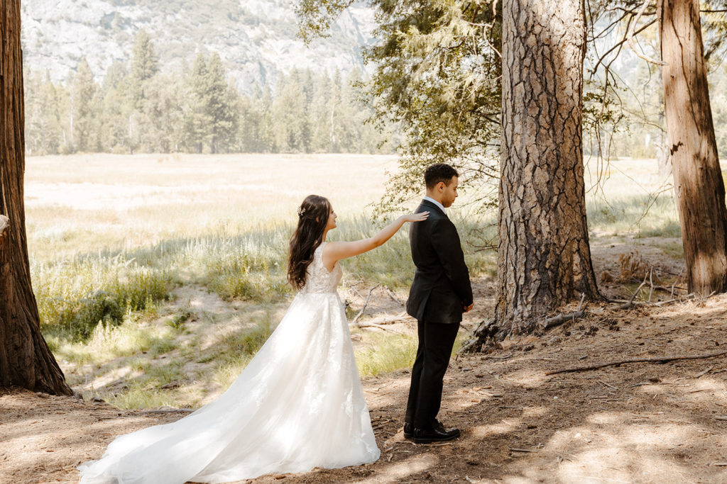 rachelchristophersonphotos-swinging bridge-yosemite elopement-yosemite elopement-swinging bridge elopement-mountain top elopement-northern california elopement-bride and groom-slick black suit-lacey floral wedding gown-bride and groom first look-first look photos