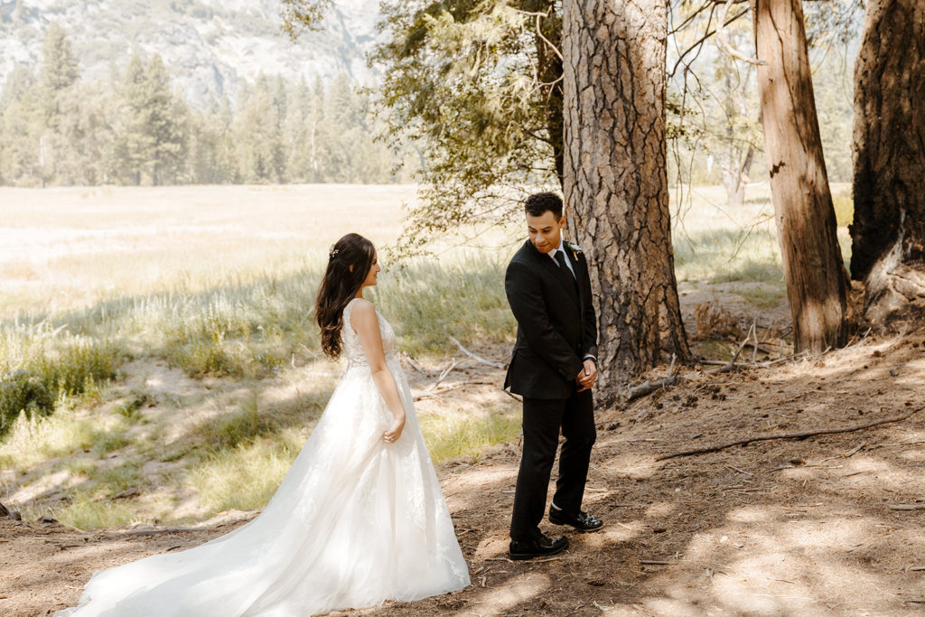 rachelchristophersonphotos-swinging bridge-yosemite elopement-yosemite elopement-swinging bridge elopement-mountain top elopement-northern california elopement-bride and groom-slick black suit-lacey floral wedding gown-bride and groom first look-first look photos