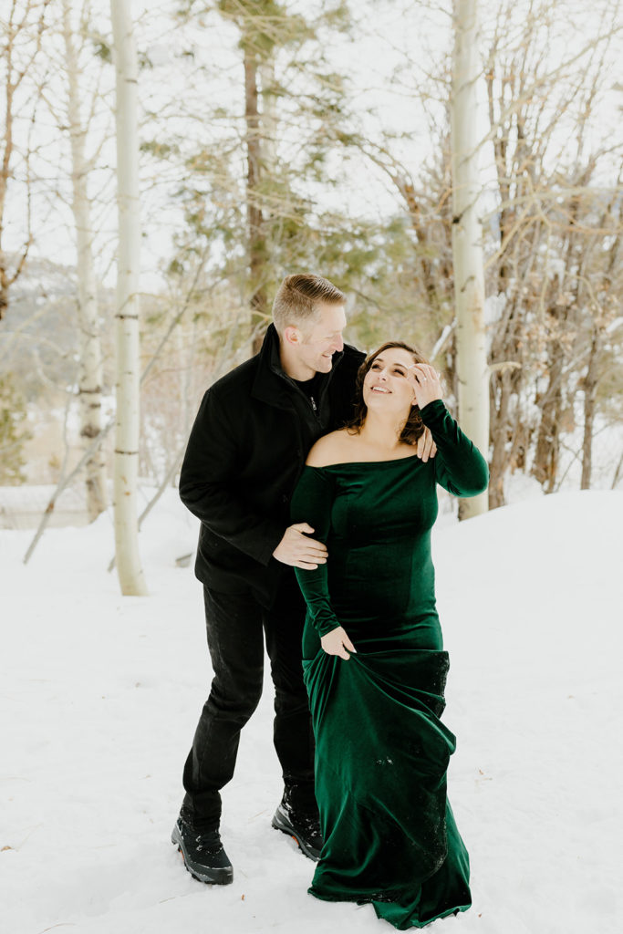 Rachel Christopherson Photography - Lake Tahoe winter engagement photos, engaged couple holding each other and laughing in front of snowy forest