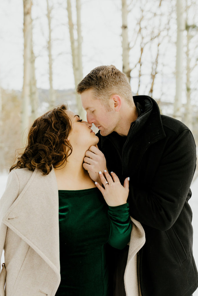 Rachel Christopherson Photography - Lake Tahoe winter engagement photos, engaged couple kissing in front of snowy forest