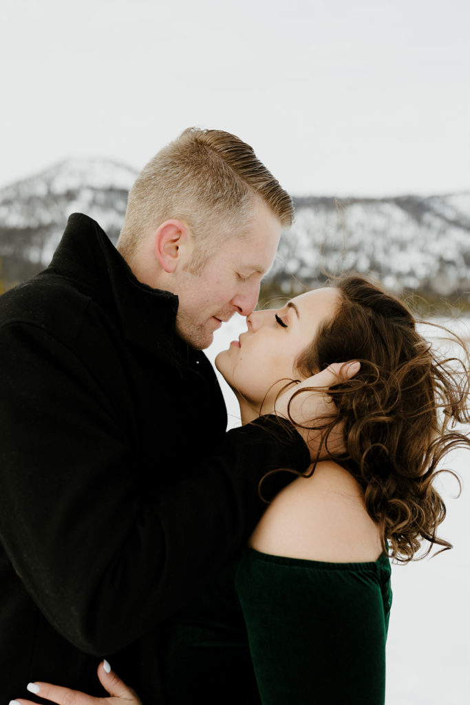 Rachel Christopherson Photography - Lake Tahoe snow engagement photos, engaged couple kissing in front of snowy mountain 