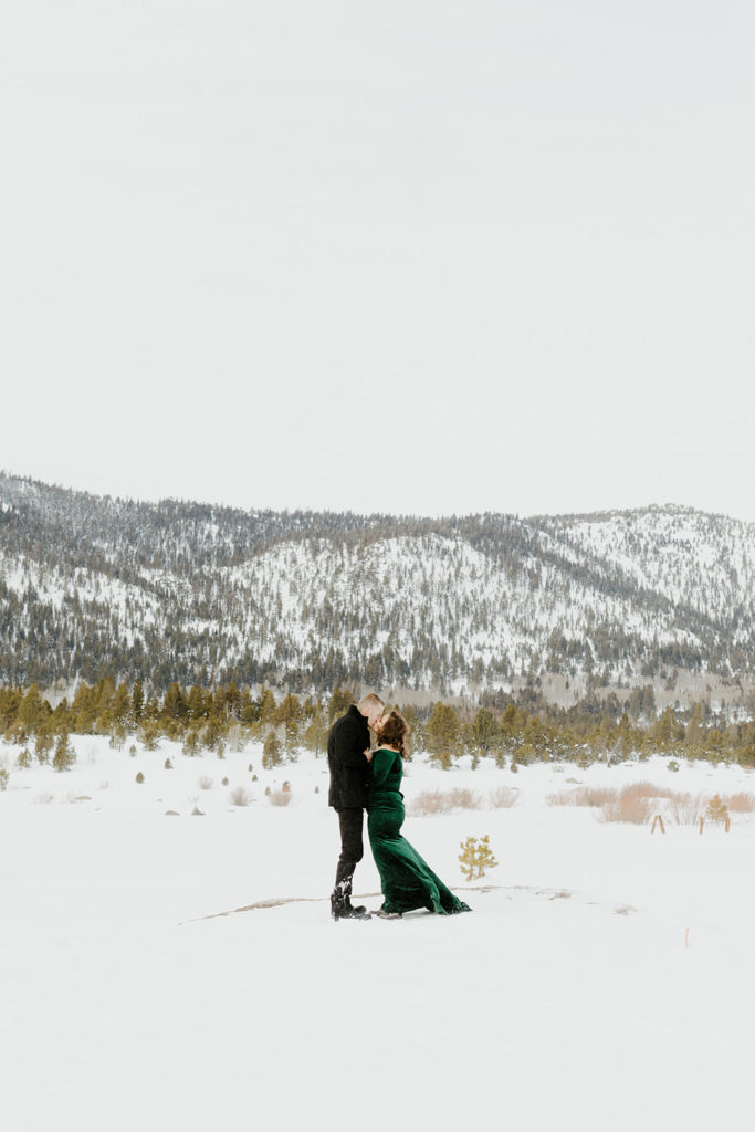 Rachel Christopherson Photography -  Lake Tahoe winter engagement photos, engaged couple kissing in front of snowy mountain
