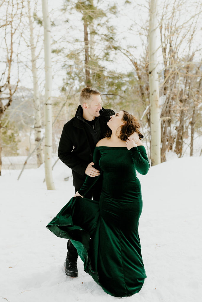 Rachel Christopherson Photography - Lake Tahoe winter engagement photos, engaged couple holding each other and laughing in front of snowy forest
