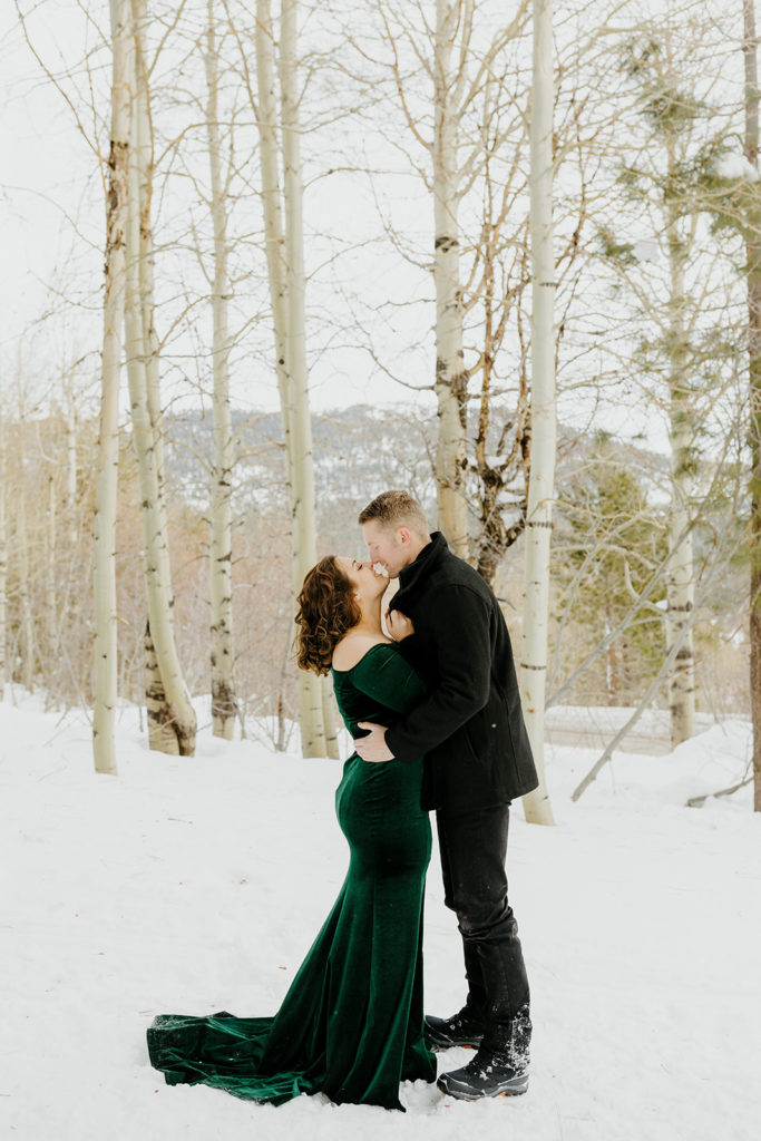 Rachel Christopherson Photography -  Lake Tahoe snowy engagement photos, engaged couple kissing in front of snowy forest