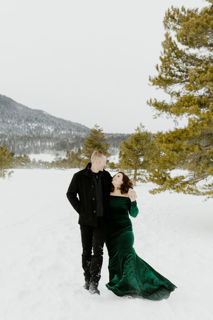 Rachel christopherson photography - engaged couple with arms around each other in snow