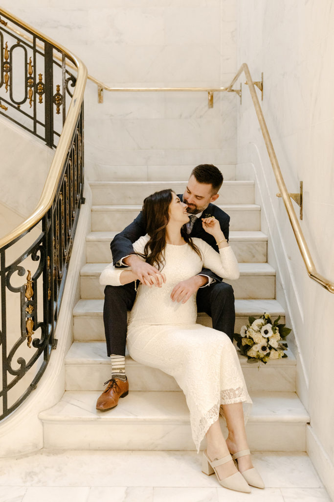 Rachel Christopherson Photogarphy-SF, San Francisco city hall elopement, San Francisco wedding, bride and groom on stairs, ivory wedding dress, gray grooms suit, neutral bouque, neutral wedding florals