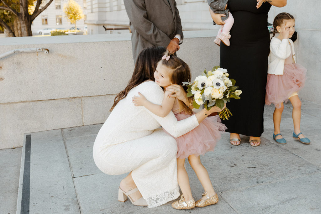 Rachel Christopherson Photographer-SF, San Francisco city hall elopement, san francisco wedding, bride hugging niece, candid wedding photos