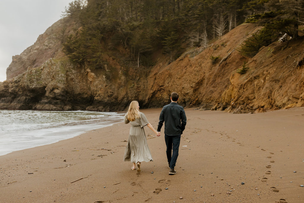 Rachel Christopherson Photography - Engaged couple holding hands on northern california beach , San Francisco engagement photos, beach engagement photos