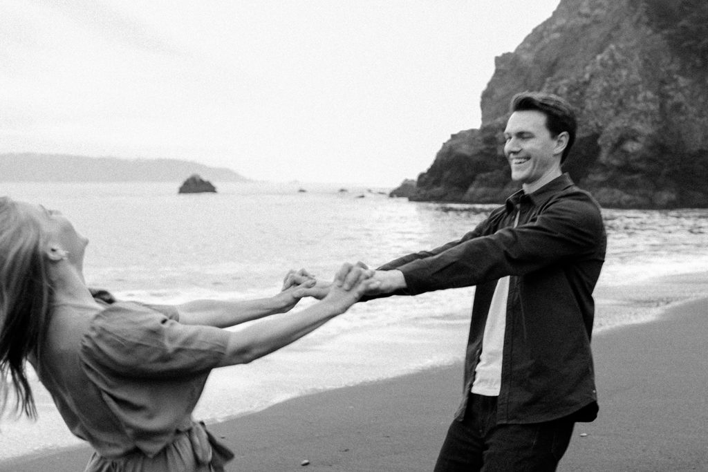 Rachel Christopherson Photography - Engaged couple holding hands on northern california beach , Marin Headlands engagement photos, beach engagement photos, black and white engagement photos