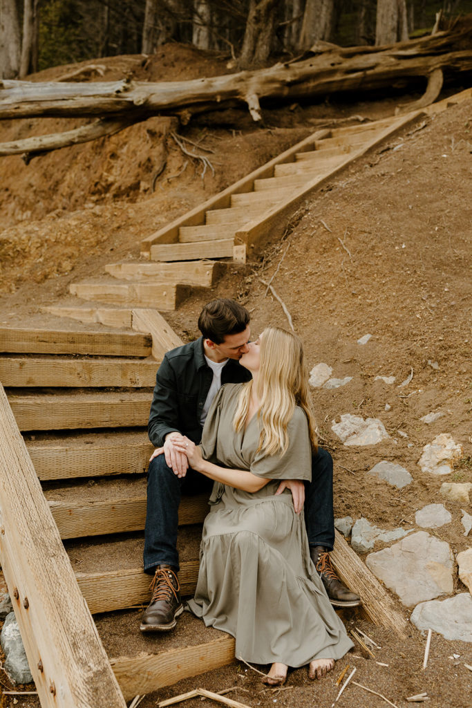 Rachel Christopherson Photography - Engaged couple kissing and sitting on stairs in kirby cove